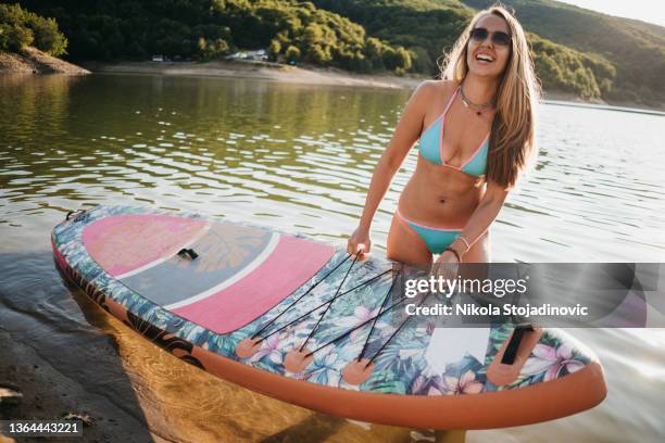 beautiful woman paddle boarding - surf dog competition stock pictures, royalty-free photos & images