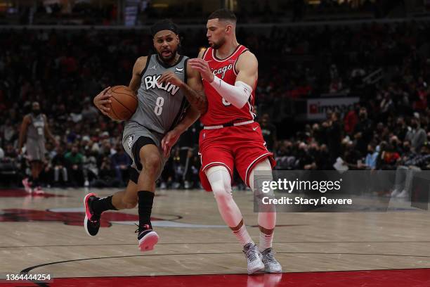 Patty Mills of the Brooklyn Nets is fouled by Zach LaVine of the Chicago Bulls during a game at United Center on January 12, 2022 in Chicago,...