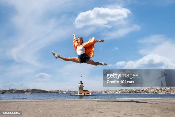 beautiful dancer dancing front of maiden's tower view in istanbul city - istanbul street stock pictures, royalty-free photos & images
