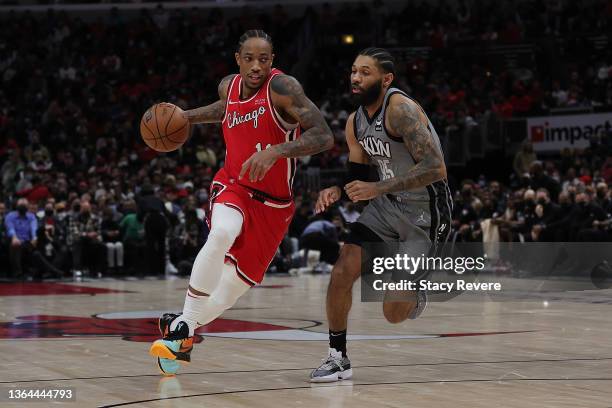 DeMar DeRozan of the Chicago Bulls is defended by DeAndre' Bembry of the Brooklyn Nets during a game at United Center on January 12, 2022 in Chicago,...