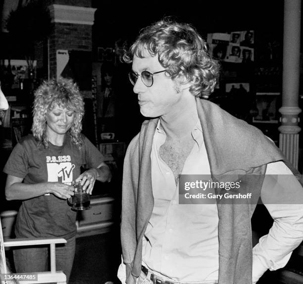 View of Rock musician Warren Zevon following an interview on MTV at Teletronic Studios, New York, New York, July 20, 1982. Visible behind him is MTV...