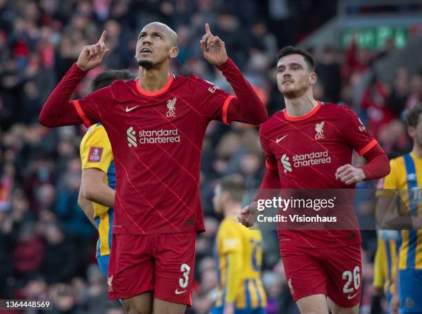 Fabinho of Liverpool celebrates scoing their team's second goal with team mate Andrew Robertson and Matthew Pennington of Shrewsbury Town looking...