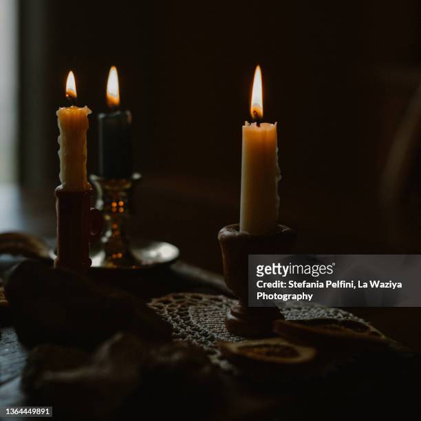 three lit beeswax candles - mourning candles stock pictures, royalty-free photos & images