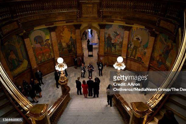 Gov. Jared Polis poses for photos as photography Jack Dempsey works creative angles before the governor's state of the state address at the Colorado...