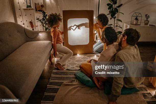 children playing shadow at home with parents making heart - shadow puppets stock pictures, royalty-free photos & images