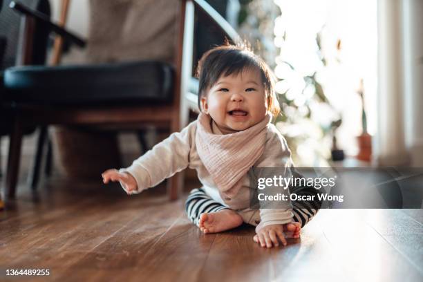 cheerful asian baby girl smiling at camera - sólo bebés fotografías e imágenes de stock
