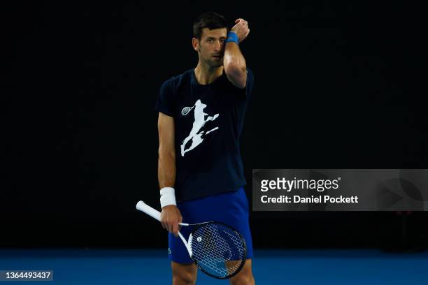 Novak Djokovic of Serbia wipes sweat during a practice session ahead of the 2022 Australian Open at Melbourne Park on January 14, 2022 in Melbourne,...