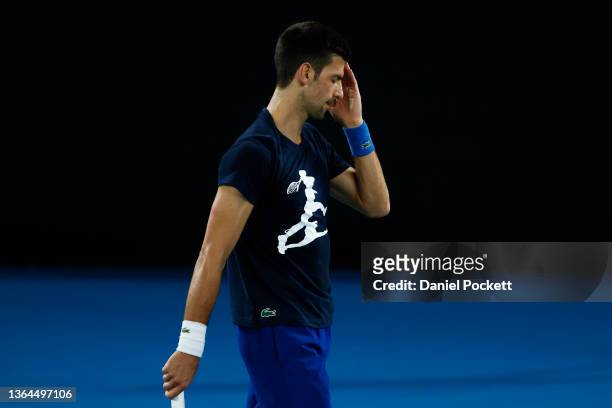 Novak Djokovic of Serbia reacts during a practice session ahead of the 2022 Australian Open at Melbourne Park on January 14, 2022 in Melbourne,...