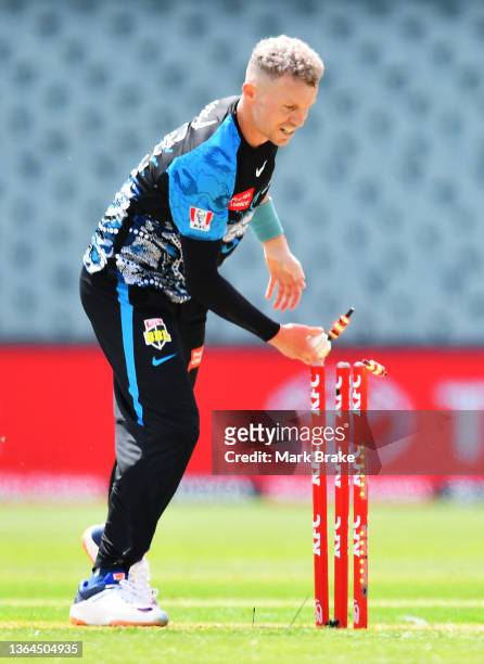 Peter Siddle of the Strikers takes off the bails to run out Chris Sabburg of the Scorchers during the Men's Big Bash League match between the...