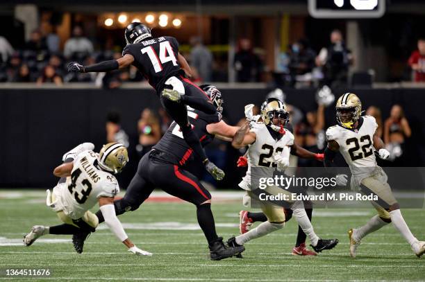 Russell Gage Jr. #14 of the Atlanta Falcons leaps over Marcus Williams of the New Orleans Saints in the second half at Mercedes-Benz Stadium on...