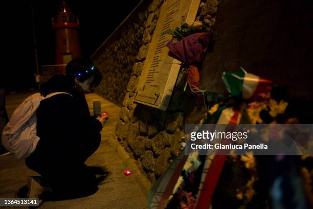 People hold candles during the torchlight procession in memory of the victims on the 10th anniversary of the Costa Concordia cruise ship wreck, on...
