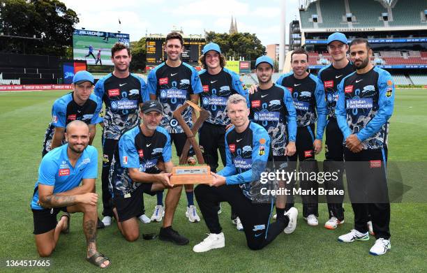 Jason Gillespie coach of the Strikers and Peter Siddle of the Strikers hold the Jason Gillespie Trophy with the team after winning the Men's Big Bash...