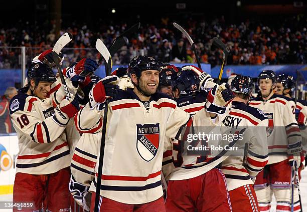 Mike Rupp of the New York Rangers and teammates celebrate after defeating the Philadelphia Flyers by a score of 3-2 during the 2012 Bridgestone NHL...