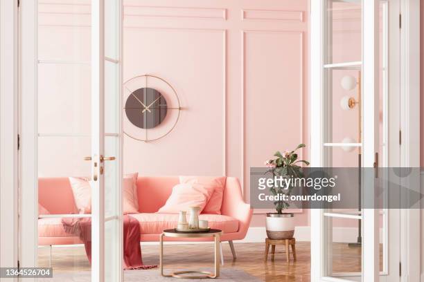 entrance of living room with pink sofa, potted plant and coffee table - pink colour stock pictures, royalty-free photos & images