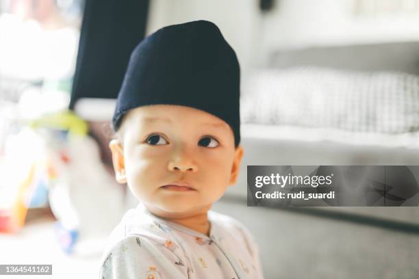 baby wearing a peci hat - cute muslim boys stock pictures, royalty-free photos & images
