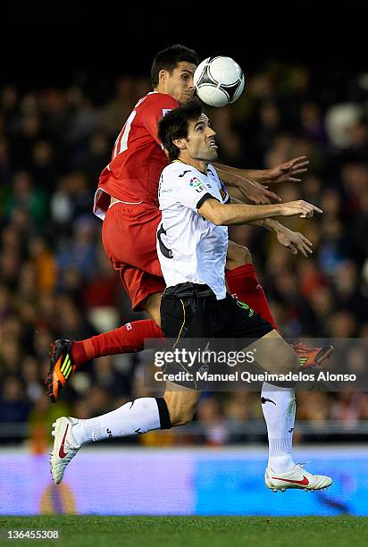 David Albelda of Valencia competes for the ball with Manu del Moral of Sevilla during the round 16 Copa del Rey 1st leg match between Valencia and...