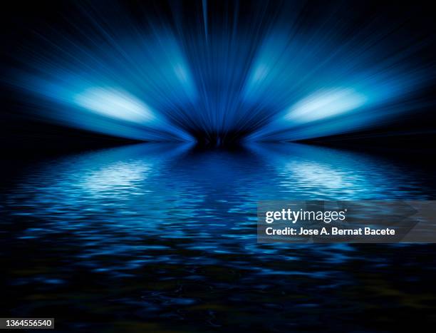 abstract background with moving light trails reflected on a water surface. - vanish stock pictures, royalty-free photos & images