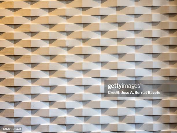 full frame of modern interior wall of white bricks in triangular shape. - block of marble stock-fotos und bilder