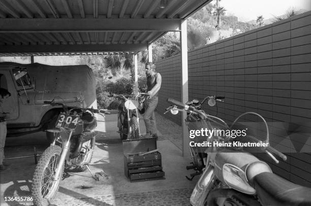 Portrait of celebrity actor Steve McQueen with his son, Chad McQueen, and his bike collection in his garage. Palm Springs, CA 6/13/1971 CREDIT: Heinz...