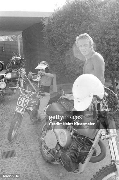 Portrait of celebrity actor Steve McQueen with his son, Chad McQueen, and his bike collection in his garage. Palm Springs, CA 6/13/1971 CREDIT: Heinz...