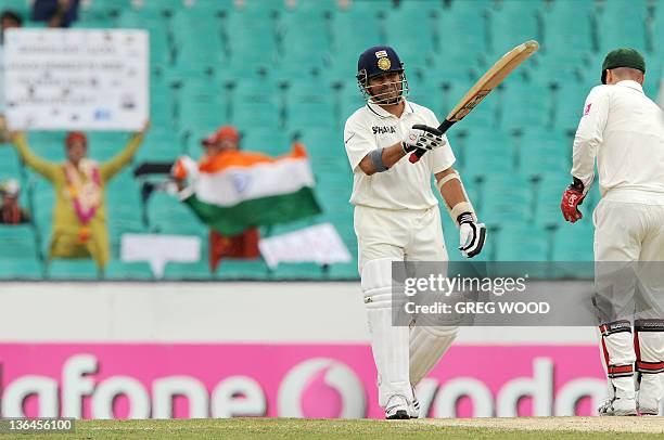 India's Sachin Tendulkar raises his bat after reching his 50 on day four of the second cricket Test against Australia at the Sydney Cricket Ground on...