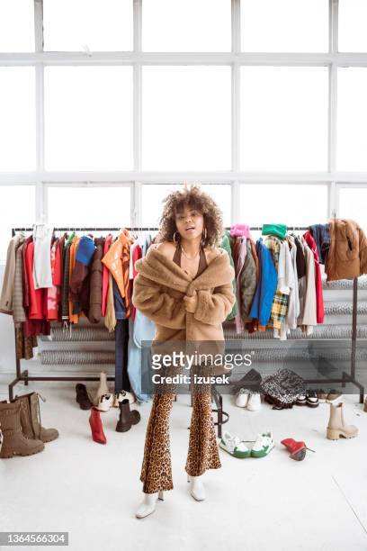female fashion influencer wearing fake fur coat - bronze boot stock pictures, royalty-free photos & images