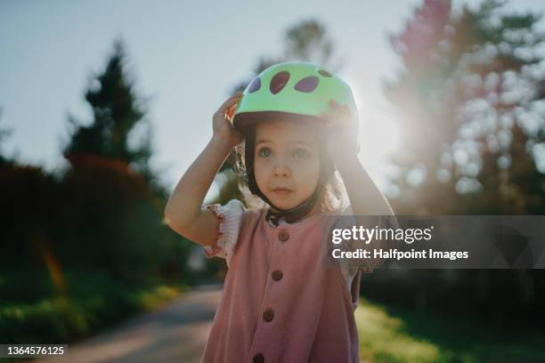 waist up of small girl in cycling helmet outdoors. - biker girl foto e immagini stock
