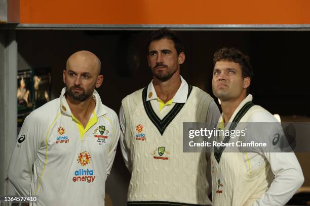 Nathan Lyon, Mitchell Starc and Alex Carey of Australia look on as rain delays play during day one of the Fifth Test in the Ashes series between...