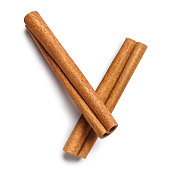 Two delicious cinnamon sticks on white