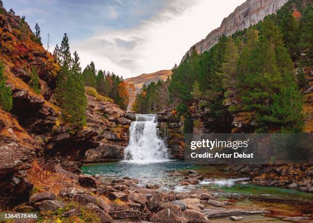 dramatic landscape with autumn colors and waterfall in the pyrennes. - the valley stockfoto's en -beelden