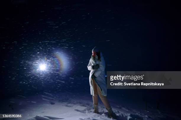 girl in heavy snow - woman snow outside night stockfoto's en -beelden