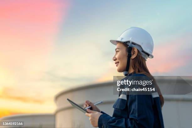 petroleum oil refinery engineer worker in oil and gas industrial with personal safety equipment ppe to inspection follow checklist by tablet. classic energy business concept. - planta petroquímica fotografías e imágenes de stock