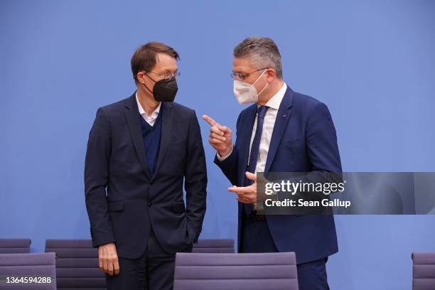 Federal Health Minister Karl Lauterbach and Robert Koch Institute President Lothar Wieler arrive to speak to the media to provide an update...