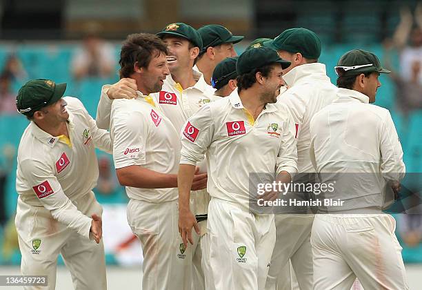 Ben Hilfenhaus of Australia celebrates with team mates after taking the wicket of MS Dhoni of India during day four of the Second Test Match between...