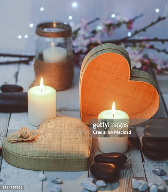 for valentine's day, a zen and romantic atmosphere for a moment of relaxation in a spa, in a cure center or at home - christmas candle stock pictures, royalty-free photos & images