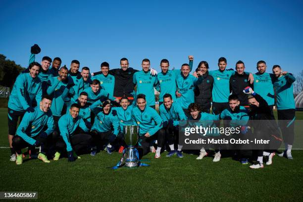 Players of FC Internazionale Milano pose for a photo with the Italian SuperCup trophy prior to the FC Internazionale training session at the club's...