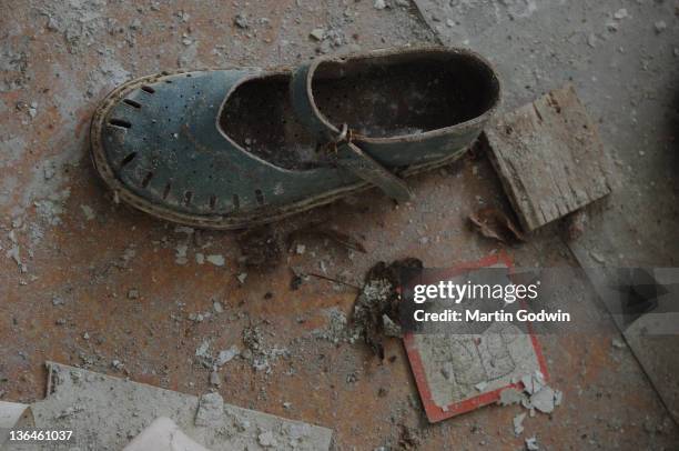 Child's shoe in a deserted nursery school in the abandoned town of Pripyat, inside the Chernobyl Exclusion Zone, Ukraine, 17th March 2006.