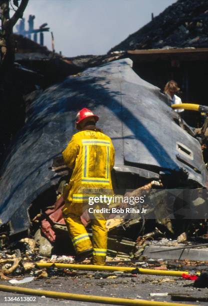 Los Angeles County firefighters and mutual aid agencies work within the debris field after a mid-air collision with Aeromexico Flight 498 and Piper...