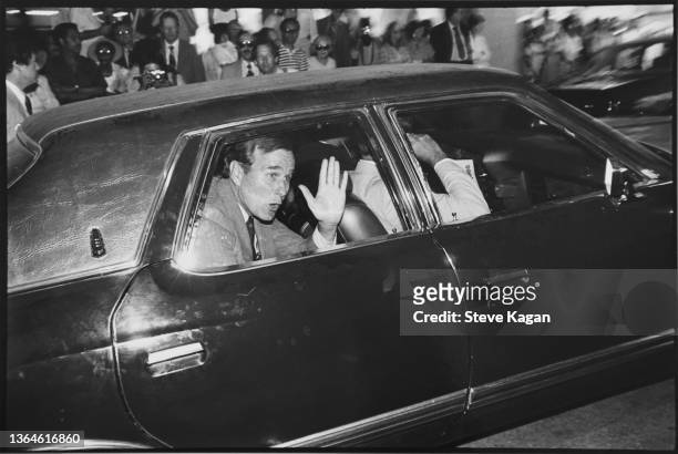 American oil executive George W Bush waves from a car outside the Republican National Convention at Joe Louis Arena, Detroit, Michigan, July 14 - 17,...