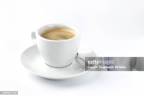 cup of coffee with spoon on white background. - cup saucer stock pictures, royalty-free photos & images