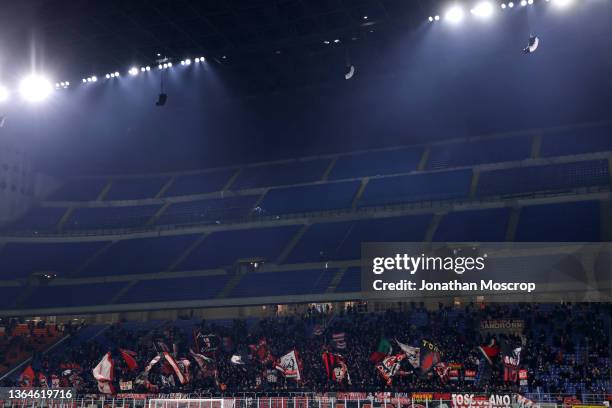 Milan fans in the lower tier wave flags, current stadium capacity is 50 per cent, from the next matchday capacity will be furhter reduced due to...