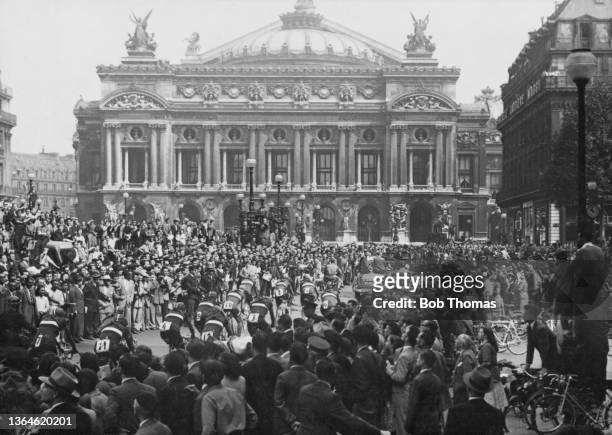 The Italian team and others pass through the crowd of fans in Place de l'Opera to move to Livry-Gargan for the official start of the 36th Tour de...