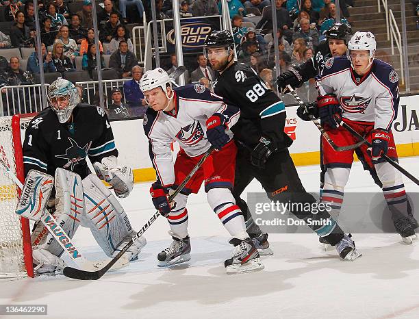 Thomas Greiss, Brent Burns, and Andrew Desjardins of the San Jose Sharks defend the net against Derek Dorsett and Samuel Pahlsson the Columbus Blue...