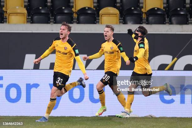 Christoph Daferner of Dresden celebrates his team's first goal with teammates Julius Kade and Brandon Borrello during the Second Bundesliga match...