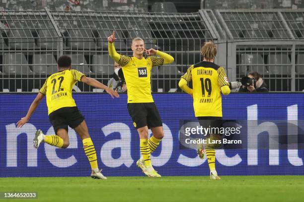 Erling Haaland of Borussia Dortmund celebrates his team's third goal with teammates Jude Bellingham and Julian Brandt during the Bundesliga match...