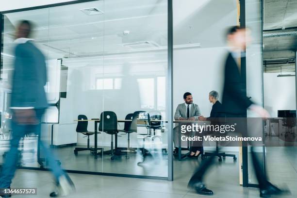 business meeting at busy corporate office. - financial reports bildbanksfoton och bilder