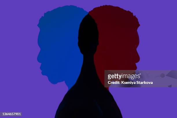 black man in red spotlights in a photo studio on a red background silhouette - african american man depressed bildbanksfoton och bilder