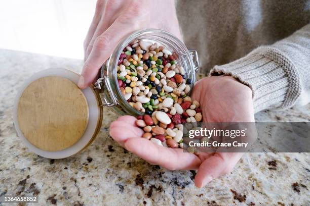 man pours mixed beans into palm of hand - black eyed peas food stock pictures, royalty-free photos & images