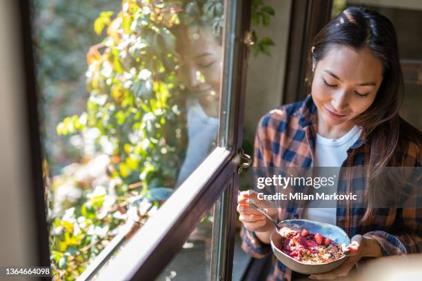 a modern asian woman eats a fruit saladat a restaurant in isnatbul - low carb stock pictures, royalty-free photos & images