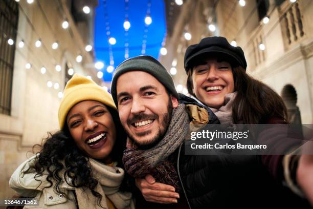 fun photography of three mixed raced friends taking a selfie. - mid twenties fun foto e immagini stock